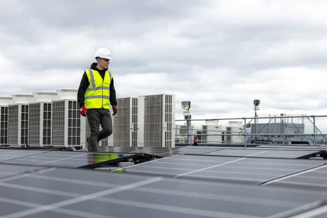 Technician inspecting rooftop mechanical equipment